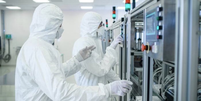 Semiconductor manufacturing employees wearing personal protection equipment